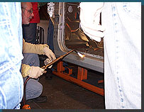 Instructor Rich Webb tinning a door jamb dent prior to soldering