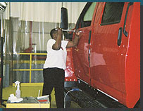 A student using a slide hammer glue puller